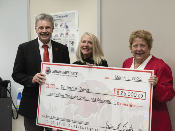 Lamar University President Jaime Taylor standing with Dr. Terri Davis and Dr. Brenda Nichols